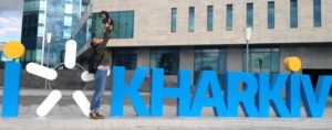 willie with a new friend in front of the Kharkiv sign